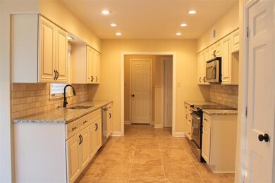 Beautifully renovated kitchen includes granite, fi