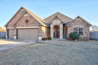 French country inspired facade with a garage, bric
