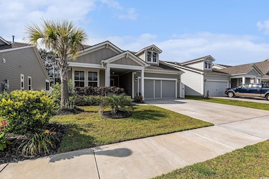 View of front of home with board and batten siding, driveway, a front lawn, a garage, and roof with shingles