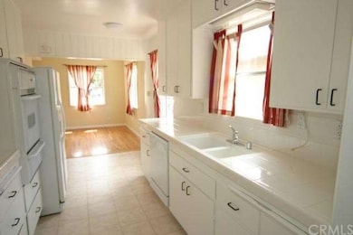 Kitchen with tiled counter tops & built-ins