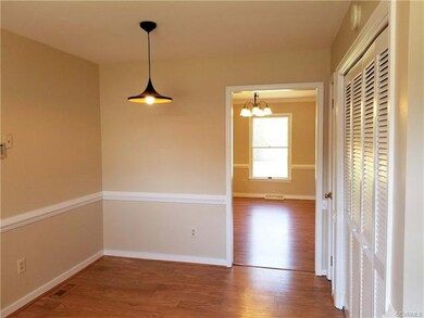 Kitchen breakfast area looks into dining room.