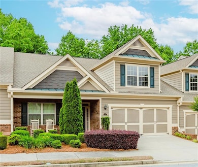 Craftsman-style home featuring brick siding, a standing seam roof, concrete driveway, and roof with shingles
