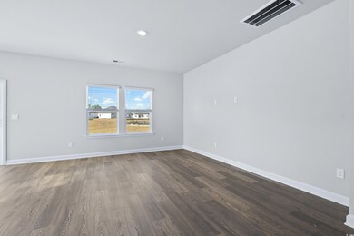 Empty room with dark hardwood / wood-style floors