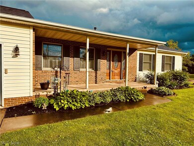 View of front of house with covered porch and a front yard