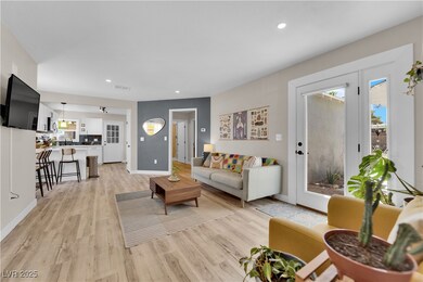 Living area with light wood-style floors, baseboar