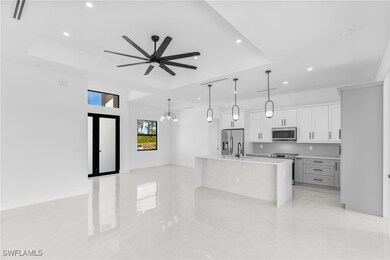 Kitchen with stainless steel appliances, a raised