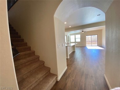 Enter into the home from foyer through lovely arch