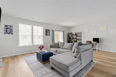 Living room featuring baseboards, light wood finis