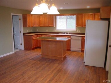 Kitchen with door to large pantry / laundry room.