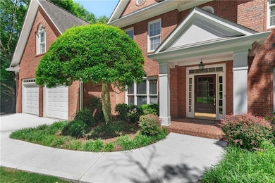 Doorway to property with brick siding, driveway, and a porch