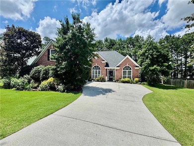 View of front of home featuring brick siding and driveway