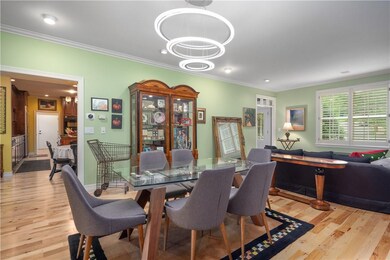 One of a kind chandelier hangs over dining area