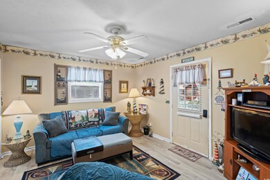 Living area with plenty of natural light, wood fin