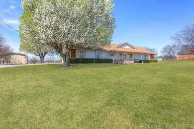Large front yard and driveway leads to shed and ca