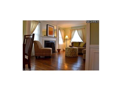 View of living room from dining room.  Wood burnin