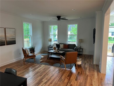 Living room featuring ornamental molding, wood fin