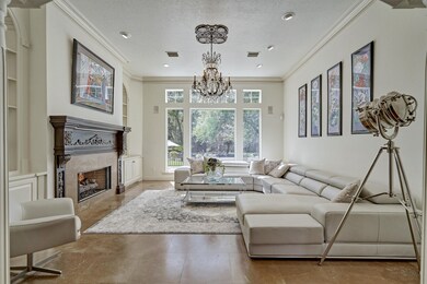 Formal living room with built-ins, gas log fireplace and lots of natural light. Home has built-in speakers throughout.