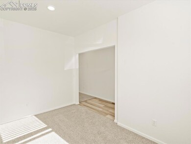 Carpeted empty room featuring baseboards and recessed lighting