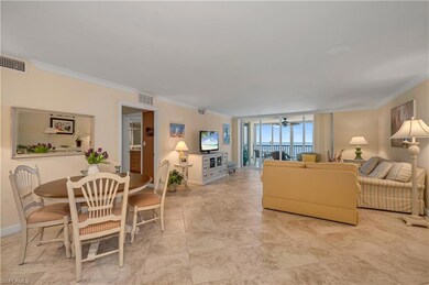Living room with ceiling fan and ornamental moldin