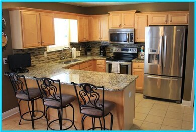 Beautiful kitchen with granite, glass tiled back s