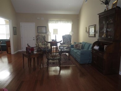 Spacious Great Room with vaulted ceiling and hardw