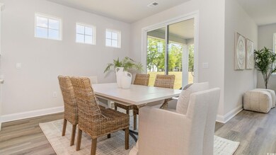 Dining space featuring light wood-style flooring and baseboards