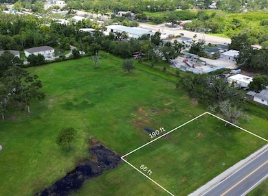 View looking northwest over the 12,632 sq ft parcel at 612 27th St E. This clearly marked 66 ft x 190 ft buildable lot offers a level canvas in a well-connected corridor, ideal for single-family or duplex development. Located directly off a paved public road, the lot has easy access to utilities and public infrastructure.
