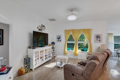 Living area with plenty of natural light and wood finished floors