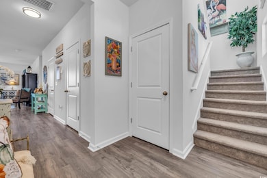 Entrance foyer with hardwood / wood-style floors