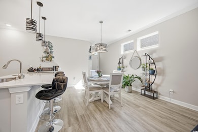 Dining room with crown molding and light wood-type flooring