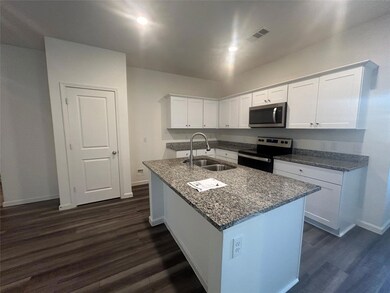 Kitchen with white cabinetry, stainless steel appliances, dark hardwood / wood-style flooring, and sink
