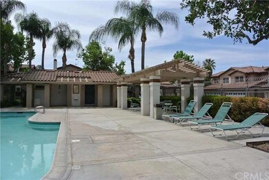 Pool area with lounge chairs, shower and bathrooms
