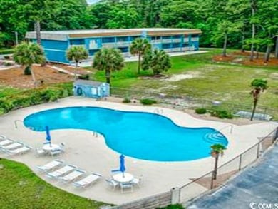 Community pool with a patio
