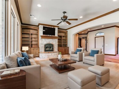 VIRTUALLY STAGED:Living room with ceiling fan, bui