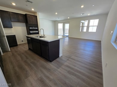 Kitchen with a sink, visible vents, wood finished