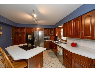 Cherry cabinetry with double wall oven, pantry and