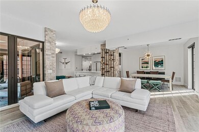 Living area with baseboards, visible vents, an inv