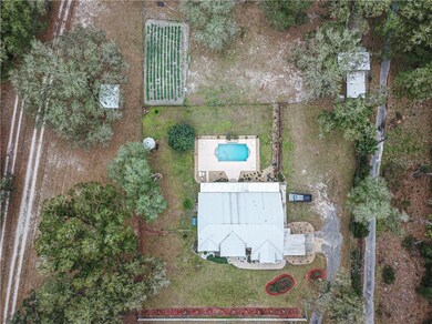 Aerial view of main home with pool