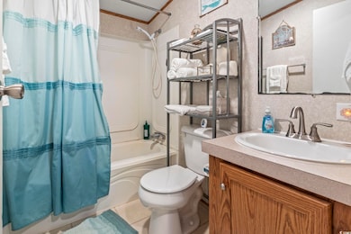 Full bathroom with vanity, a textured ceiling, sho