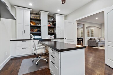 Office featuring a ceiling fan, recessed lighting, dark wood finished floors, built in study area, and crown molding