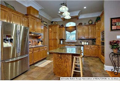 Kitchen has lots of cabinets and stainless applian