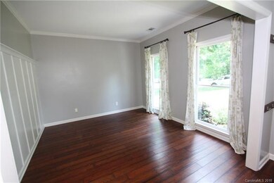 Formal living room with oversized windows and craf