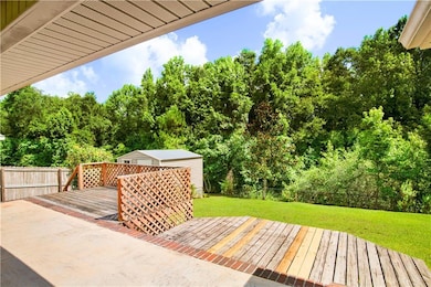 Wooden terrace featuring view of scattered trees