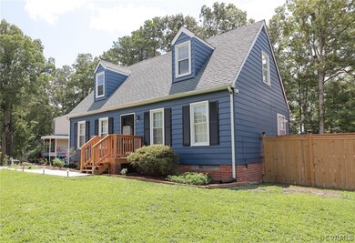 Cape cod-style house with a front yard