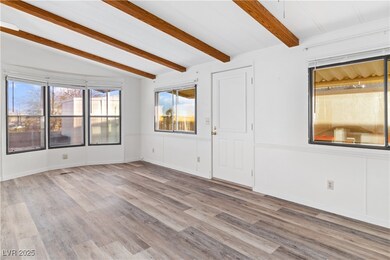 Living room featuring lofted ceiling with beams an