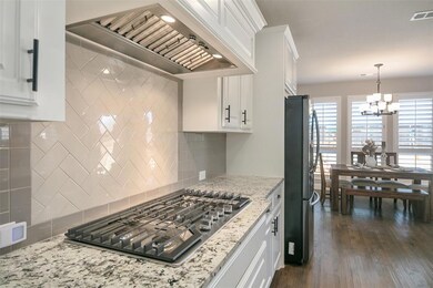 A 5 burner gas stove with a gorgeous vent hood for
