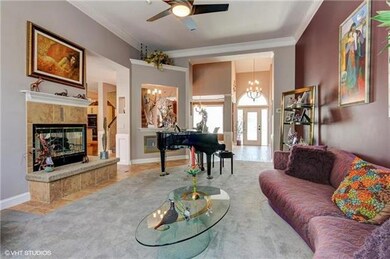 Formal living room has a wet bar between it and th