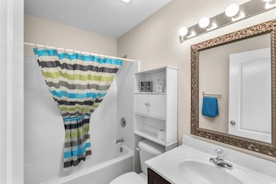 Full bathroom featuring vanity, shower / tub combo