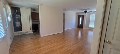 Spare room with water heater, wood-type flooring, 