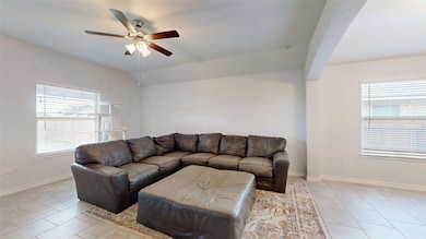 Living room featuring a ceiling fan, healthy amoun